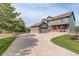 Two-story home featuring a spacious driveway, attached garage, and a well-maintained lawn at 23427 Song Bird Hills Pl, Parker, CO 80138