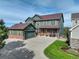 Two-story home with brick and siding, attached garage, and well-kept front yard at 23427 Song Bird Hills Pl, Parker, CO 80138