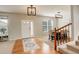 Inviting foyer with hardwood floors, staircase, and ample natural light, showcasing a welcoming entrance at 23427 Song Bird Hills Pl, Parker, CO 80138