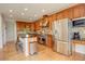 Spacious kitchen featuring stainless steel appliances, custom cabinetry, and an island with bar seating at 23427 Song Bird Hills Pl, Parker, CO 80138
