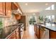 Well-equipped kitchen with stainless steel appliances, granite countertops, and wood flooring at 23427 Song Bird Hills Pl, Parker, CO 80138
