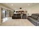 Open living room area features comfortable seating, and access to a patio and a bar area at 23427 Song Bird Hills Pl, Parker, CO 80138