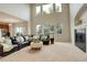 Bright living room boasting soaring windows, a cozy fireplace, and comfortable seating at 23427 Song Bird Hills Pl, Parker, CO 80138