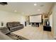 Open concept living room with projector screen and comfortable seating at 23427 Song Bird Hills Pl, Parker, CO 80138