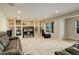 Spacious living room with built-in shelving and a large window view with a ceiling-mounted projector at 23427 Song Bird Hills Pl, Parker, CO 80138