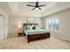 Charming bedroom featuring a tray ceiling, a window with shutters and a cozy, inviting bed at 23427 Song Bird Hills Pl, Parker, CO 80138