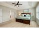 Bright bedroom with a tray ceiling, stylish decor, and double door closet access at 23427 Song Bird Hills Pl, Parker, CO 80138