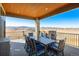 Covered outdoor dining area with wood-paneled ceiling, stone columns, and panoramic views at 3210 Mallard Creek Rd, Berthoud, CO 80513