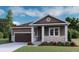 Charming single-story home with brown siding, white trim, and a well-manicured front lawn at 1353 Lumber Ridge S Cir, Erie, CO 80516