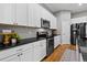 Well-equipped kitchen with stainless steel appliances, black countertops, and ample cabinet space at 14284 W 88Th Dr # B, Arvada, CO 80005