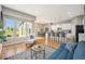 Bright living room with hardwood floors, large windows, and open floor plan to the kitchen and dining area at 14284 W 88Th Dr # B, Arvada, CO 80005