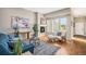Cozy living room featuring a fireplace, large windows, comfortable seating, and a stylish area rug at 14284 W 88Th Dr # B, Arvada, CO 80005