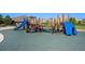 Community playground with blue slides, climbing structures and cushioned ground at 14284 W 88Th Dr # B, Arvada, CO 80005