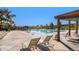 Inviting community swimming pool with lounge chairs and pergola covered seating area at 14284 W 88Th Dr # B, Arvada, CO 80005
