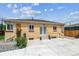 Backyard exterior with patio, white double doors, rock garden, and mature shrubbery at 2196 W 56Th Ave, Denver, CO 80221