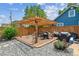 Backyard with patio featuring a pergola, grill, outdoor seating and gravel at 2196 W 56Th Ave, Denver, CO 80221