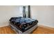 Inviting bedroom with hardwood floors, and a colorful blanket adding a touch of comfort at 2196 W 56Th Ave, Denver, CO 80221