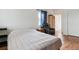 Comfortable bedroom featuring hardwood floors, a bed, and a leather recliner chair at 2196 W 56Th Ave, Denver, CO 80221