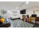 Cozy bedroom or flex space featuring a mounted TV and contemporary flooring at 2196 W 56Th Ave, Denver, CO 80221