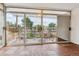 Enclosed back porch with tile floors, sliding glass windows, and chairs to enjoy the outside at 2196 W 56Th Ave, Denver, CO 80221
