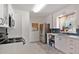 Bright kitchen with white cabinets, stainless steel appliances, and blue backsplash at 2196 W 56Th Ave, Denver, CO 80221