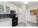 A cozy kitchen with white cabinets, blue backsplash, and modern appliances at 2196 W 56Th Ave, Denver, CO 80221