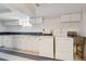 Spacious laundry area with white cabinets, washer, dryer, utility sink, and unique tiled backsplash at 2196 W 56Th Ave, Denver, CO 80221