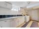 Bright laundry room featuring ample storage space with white cabinets and a laundry sink at 2196 W 56Th Ave, Denver, CO 80221