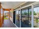 Relaxing enclosed porch with wood floors, glass doors, and screens at 2196 W 56Th Ave, Denver, CO 80221