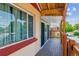 Enclosed sunroom highlighting natural light, a wooden deck, and brick accents at 2196 W 56Th Ave, Denver, CO 80221