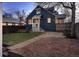 Cozy backyard with a well-maintained lawn, stone patio, and charming exterior home details at 285 E Dartmouth Ave, Englewood, CO 80113