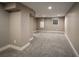 Spacious finished basement offers a cozy and versatile area with carpet and a bright window at 285 E Dartmouth Ave, Englewood, CO 80113