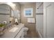 Well-lit bathroom with a modern vanity, tiled shower, and neutral color scheme at 285 E Dartmouth Ave, Englewood, CO 80113