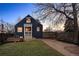 Charming exterior view of a dark blue, two-story house, boasting curb appeal and a welcoming entrance at 285 E Dartmouth Ave, Englewood, CO 80113