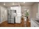 Modern kitchen featuring stainless steel appliances and white cabinets, leading to a cozy living area at 285 E Dartmouth Ave, Englewood, CO 80113