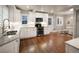 Bright kitchen with white cabinets, stainless steel appliances, and view to the dinette at 285 E Dartmouth Ave, Englewood, CO 80113