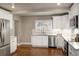 Bright kitchen featuring stainless steel appliances and white cabinetry at 285 E Dartmouth Ave, Englewood, CO 80113