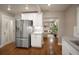 Modern kitchen with white cabinets, stainless steel appliances, and hardwood floors at 285 E Dartmouth Ave, Englewood, CO 80113