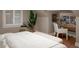 Main bedroom featuring hardwood floors, a workspace, and a tropical plant at 285 E Dartmouth Ave, Englewood, CO 80113