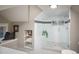 Shower room featuring gray and white tiling, a glass shower wall and door, and a small window at 285 E Dartmouth Ave, Englewood, CO 80113