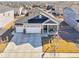 Aerial view of home featuring a three-car garage and a covered porch at 7414 E 158Th Pl, Thornton, CO 80602
