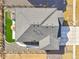 Bird's eye view of home featuring a gray roof, artificial turf, concrete driveway and fence at 7414 E 158Th Pl, Thornton, CO 80602