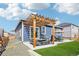 Backyard featuring an outdoor kitchen, dining space and a lush artificial lawn at 7414 E 158Th Pl, Thornton, CO 80602
