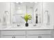 Bright bathroom featuring a double vanity, quartz countertops, and chrome fixtures at 7414 E 158Th Pl, Thornton, CO 80602