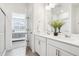 Stylish bathroom with double sink vanity, quartz countertops, and a view into the bedroom at 7414 E 158Th Pl, Thornton, CO 80602