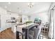 Bright open floor plan showcasing modern white kitchen and gray dining table with views to the living area at 7414 E 158Th Pl, Thornton, CO 80602
