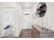 Bright entryway with wood floors, stylish console table, and a glimpse of a cozy bedroom at 7414 E 158Th Pl, Thornton, CO 80602