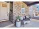 Inviting front porch with cozy seating, plants, and charming details, perfect for relaxing at 7414 E 158Th Pl, Thornton, CO 80602