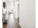 Hallway featuring hardwood floors, neutral walls, and views of a living room at 7414 E 158Th Pl, Thornton, CO 80602