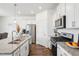 Well-lit kitchen features granite countertops, stainless steel appliances, and modern fixtures at 7414 E 158Th Pl, Thornton, CO 80602